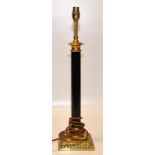 A BRASS TABLE LAMP WITH BLACK CORINTHIAN