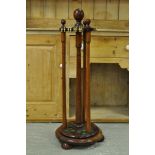 A MAHOGANY SNOOKER CUE STAND ON CIRCULAR