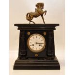 A BLACK SLATE MANTEL CLOCK WITH FAINT CA