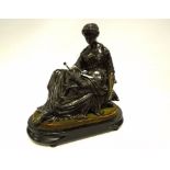 A BRONZE FIGURE OF A SEATED WOMAN WITH A