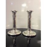 A PAIR OF SILVER COLUMN CANDLE STICKS ,