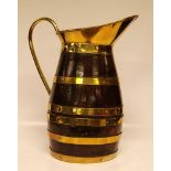 A LARGE OAK BRASS BOUND JUG WITH BRASS H