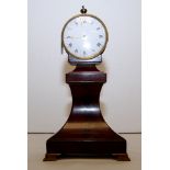 A REGENCY BRASS CLOCK ON MAHOGANY STAND