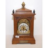 AN OAK CASED STRIKING MANTLE CLOCK, THE