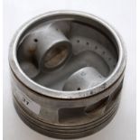 AN ALUMINIUM PISTON BELIEVED TO BE FROM