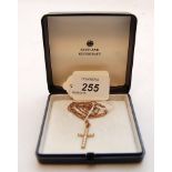 A 15CT GOLD AND PEARL CROSS AND 9CT GOLD