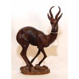 A CARVED HARDWOOD FIGURE OF A SPRINGBOK