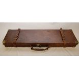 AN ANTIQUE LEATHER FITTED SHOT GUN CASE