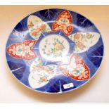 A LARGE JAPANESE IMARI PATTERN CHARGER DECORATED WITH STORK AND FLORAL PANELS IMPRESSED MARK TO