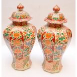 A PAIR OF JAPANESE OCTAGONAL LIDDED JARS DECORATED WITH BIRD OF PARADISE AND FLORAL PANELS 40CM