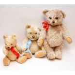 THREE MODERN STEIFF TEDDY BEARS WITH RED AND BLUE RIBBONS,