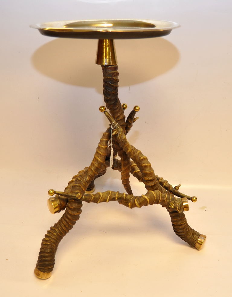 AN UNUSUAL BRASS TABLE, THE BASE CONSTRUCTED FROM 7 ANIMAL HORNS BELIEVED AFRICAN,