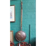 A 19th century copper warming pan, with turned wood handle