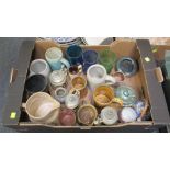 A box of various items, including tourist ware bier steins, tinted glass beakers and stoneware jugs,