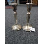 A pair of mid 20th century silver candlesticks, of neo-classical form, with loaded bases, Birmingham