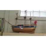 A fully rigged wooden scale model of a man-o-war, flying the red ensign and cross of St George, 82