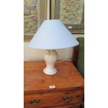 A contemporary white baluster ceramic table lamp with pale blue conical shade
