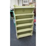 A light green painted six tier 'waterfall' open bookcase