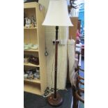 An oak standard lamp with cream silk shade