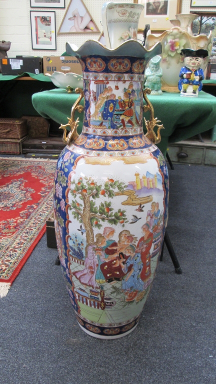 A large 20th century Japanese porcelain floor vase, decorated with reserves of figures and