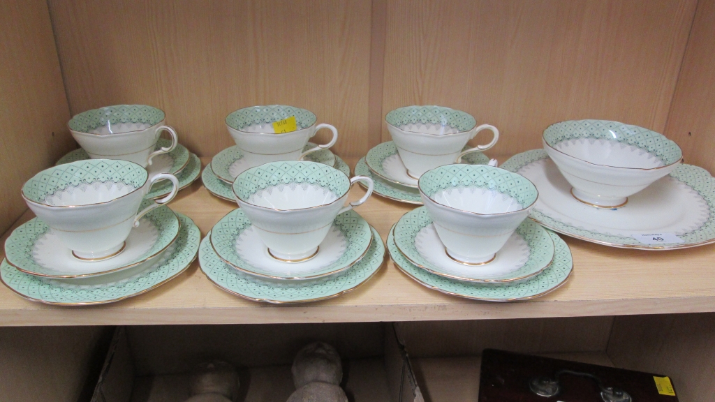 A Paragon six place tea service, comprising cups, saucers and side plates, cake plate and sugar,