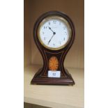 An Edwardian mahogany balloon cased mantel timepiece with eight day movement