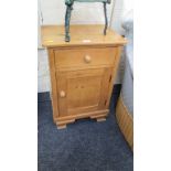 A single pine bedside cupboard on ogee bracket feet