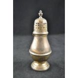 A silver sugar caster of classic baluster shape with bayonet fastening top and urn finial, London