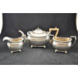 A Georgian style three piece silver teaset with gadrooned borders and ball feet, London 1918,