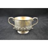 An early 20th century embossed silver porringer with acanthus leaves to lower body, maker CS