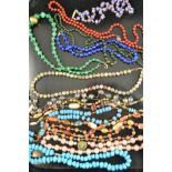 A collection of fourteen necklaces, including malachite, turquoise and lapis lazuli. CONDITION