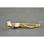 A vintage yellow metal (tests as gold) bar brooch set with moonstone and diamond dragonfly CONDITION