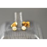 A pair of 18ct gold diamond stud earrings, each diamond  modern brilliant cut and 16 points,