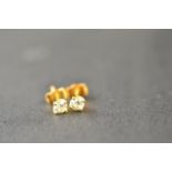 A pair of 18ct gold diamond stud earrings, each diamond  modern brilliant cut and 0.