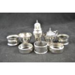 A three piece silver condiment set, together with five various silver napkin rings CONDITION REPORT: