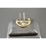 An 18ct gold ring set with solitaire 30 point diamond,