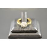 An 18ct gold ring with central 20 point diamond, clarity SI - P1 colour J, in cluster setting,