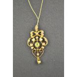 A 9ct gold pendant set with seed pearls and peridots - H 4.5cm, on a 9ct gold fine curb link