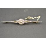 A white and yellow metal bar brooch set with seventeen diamonds - W 7.5cm. CONDITION REPORT: Good