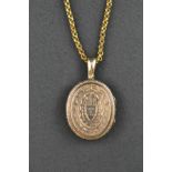 A yellow metal (probably gold plated) engraved locket on belcher necklace chain. CONDITION REPORT: