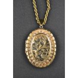 A 9ct gold engraved oval locket on a 9ct gold rope twist necklace chain - approx. total gross weight