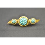 A 15ct gold bar brooch set with three clusters of turquoise, with safety chain, marked SS&L - W 4.