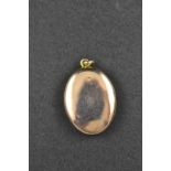 A gilt metal three section oval locket - H 2.5cm. CONDITION REPORT: Good condition.