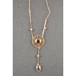 A 9ct gold pendant necklace, with central garnet in a circular setting and oval garnet suspended