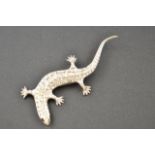 A Butler & Wilson diamante set brooch of lizard form with red eyes, marked to reverse B&W, no.