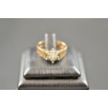 A 9ct gold ring with diamonds in floral cluster setting and bark effect to shoulders, size N1/2 -