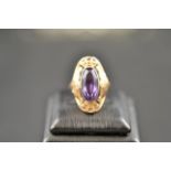 A Soviet .583 (14k) rose gold ring with oval amethyst in scrolling floral setting, size L1/2 -