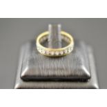 An 18ct yellow and white gold, diamond set eternity ring, size M1/2 - approx gross weight 3.6g.