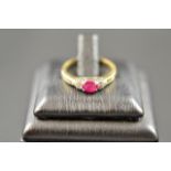 A 9ct gold ring set with ruby and diamonds, size I1/2 - approx gross weight 2.2g. CONDITION