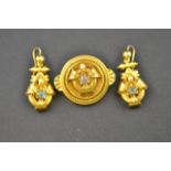 A Victorian demi parure comprising Etruscan style gilt metal drop earrings and brooch, each set with